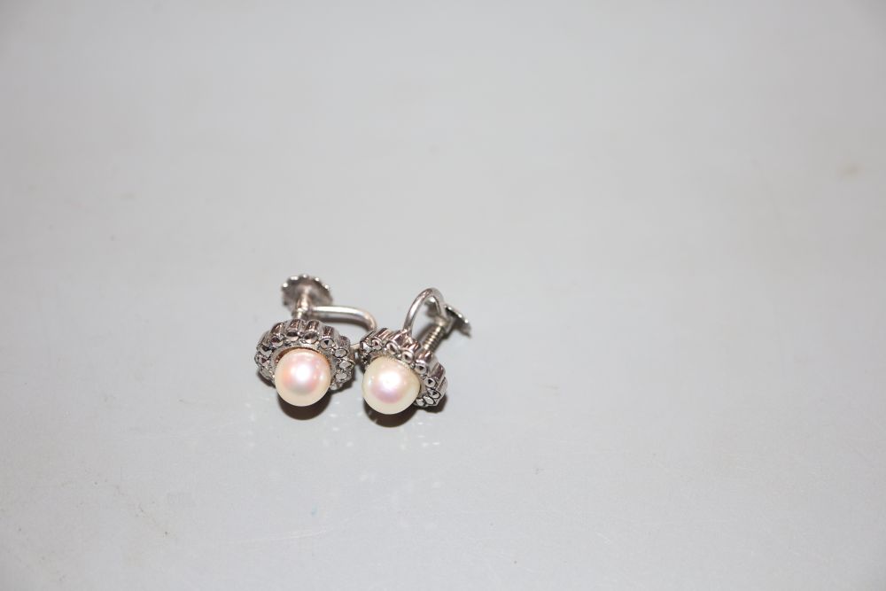 A pair of white metal (stamped silver) and cultured pearl set earclips, in a bright cut setting, 11mm, in Harrods box.